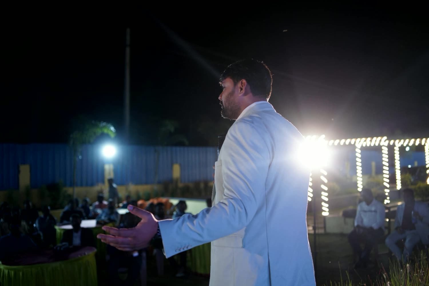 Coach Sishindri addressing a large outdoor audience